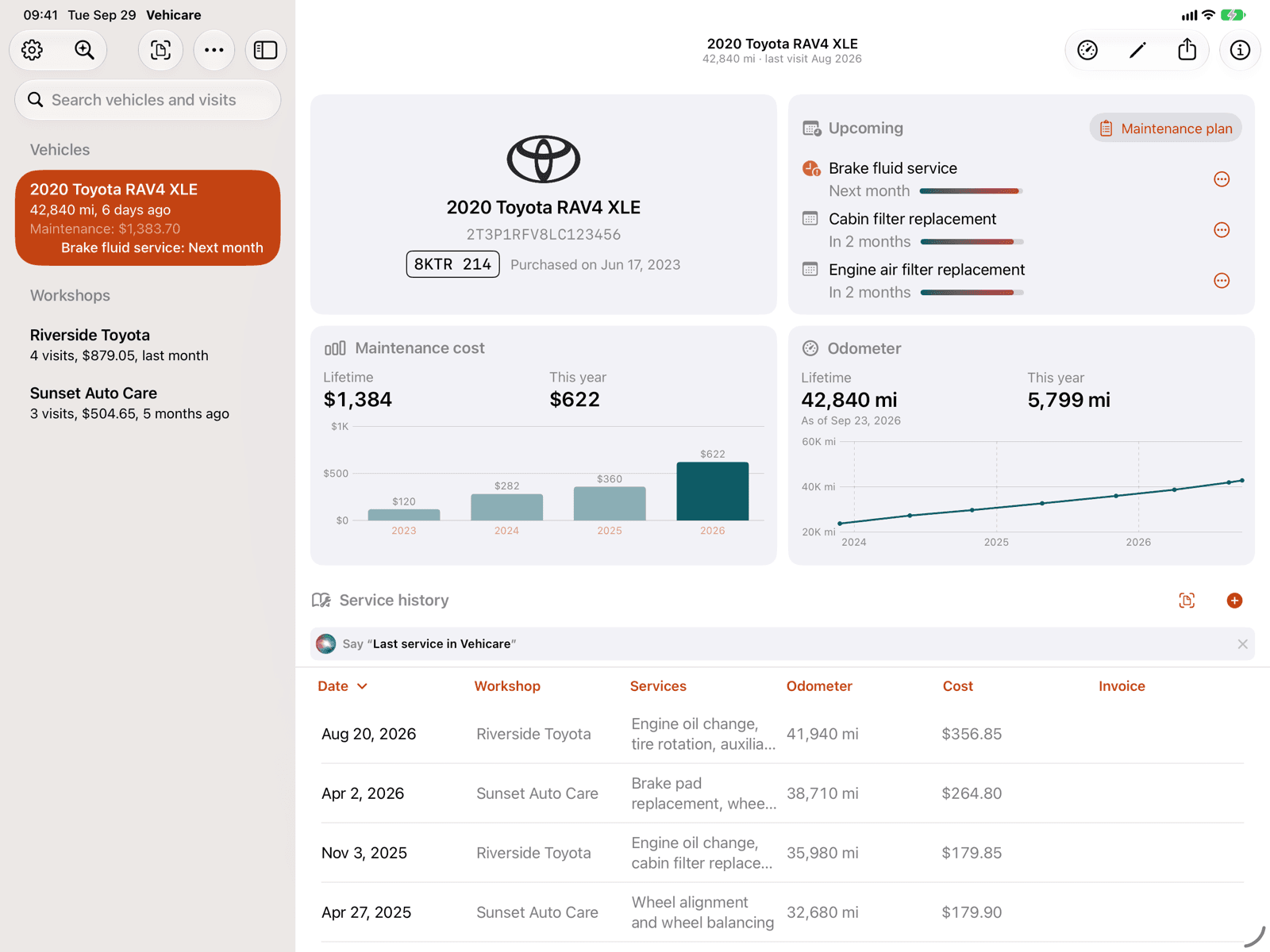 The same vehicle on an iPad in landscape: the sidebar on the left, and on the right cards for the vehicle, what’s upcoming, maintenance cost and odometer, above the service history table.