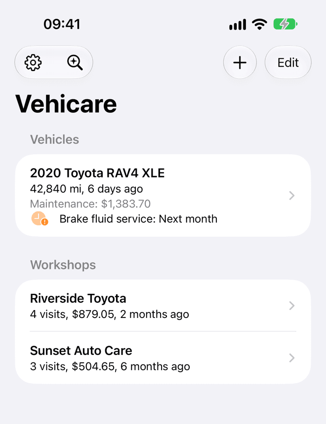 Vehicare on an iPhone: a search field, then a Vehicles section with a Toyota RAV4, and a Workshops section with two garages.